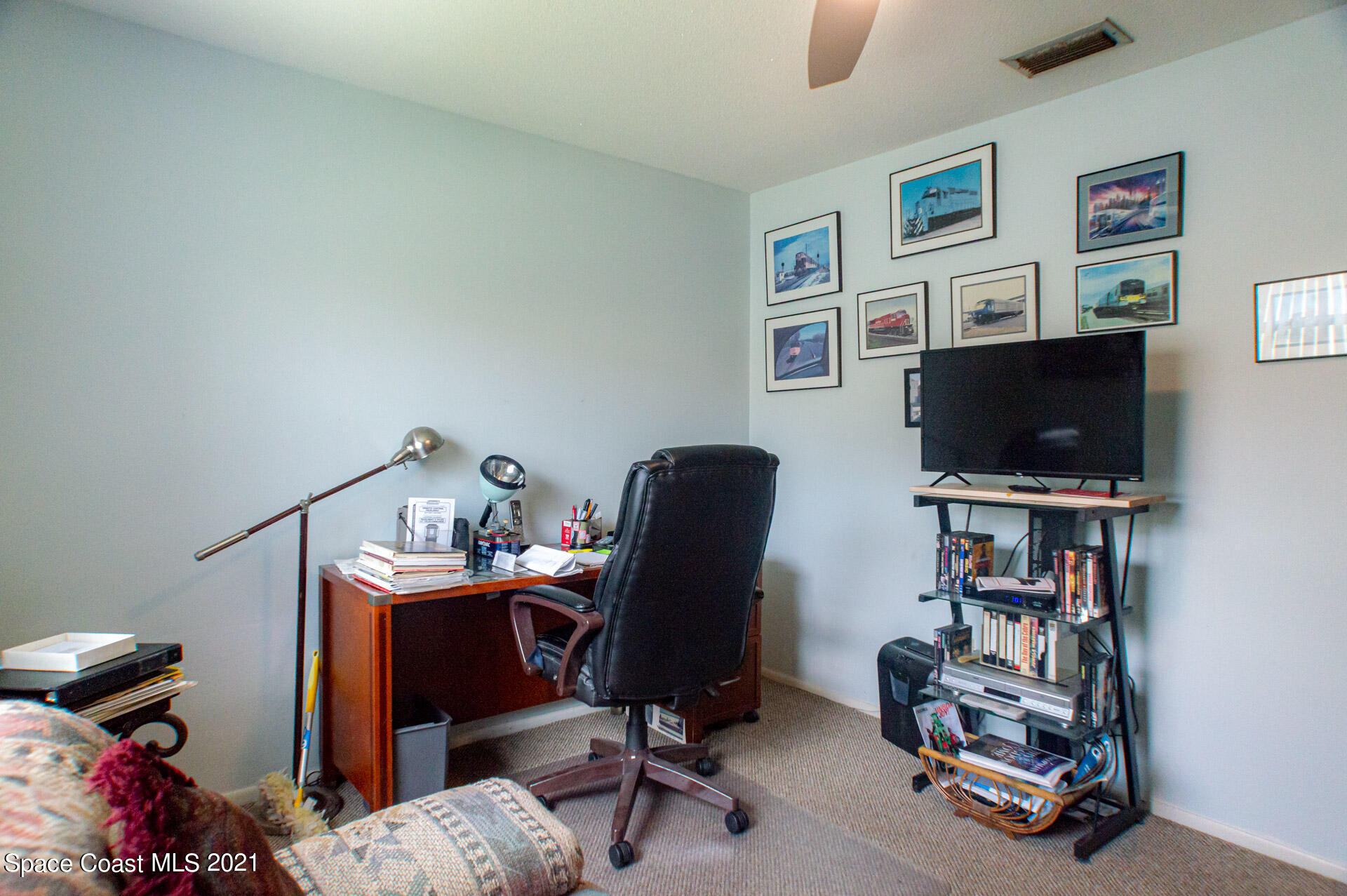2435 Ricky Road Melbourne, FL 32935 - Photo 14 of 20 a view of a workspace with furniture and a window