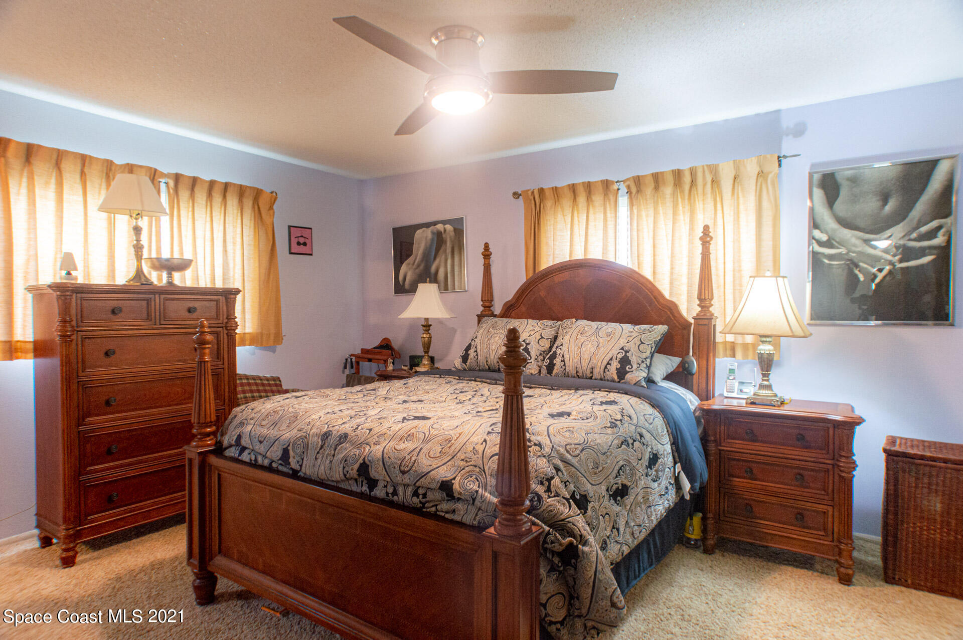 2435 Ricky Road Melbourne, FL 32935 - Photo 15 of 20 a bedroom with a bed and a dresser