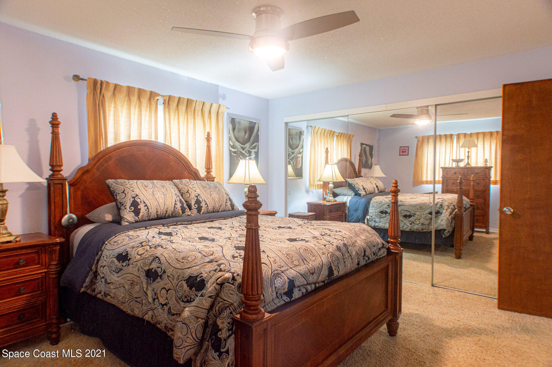 2435 Ricky Road Melbourne, FL 32935 - Photo 16 of 20 a bedroom with a bed and a mirror
