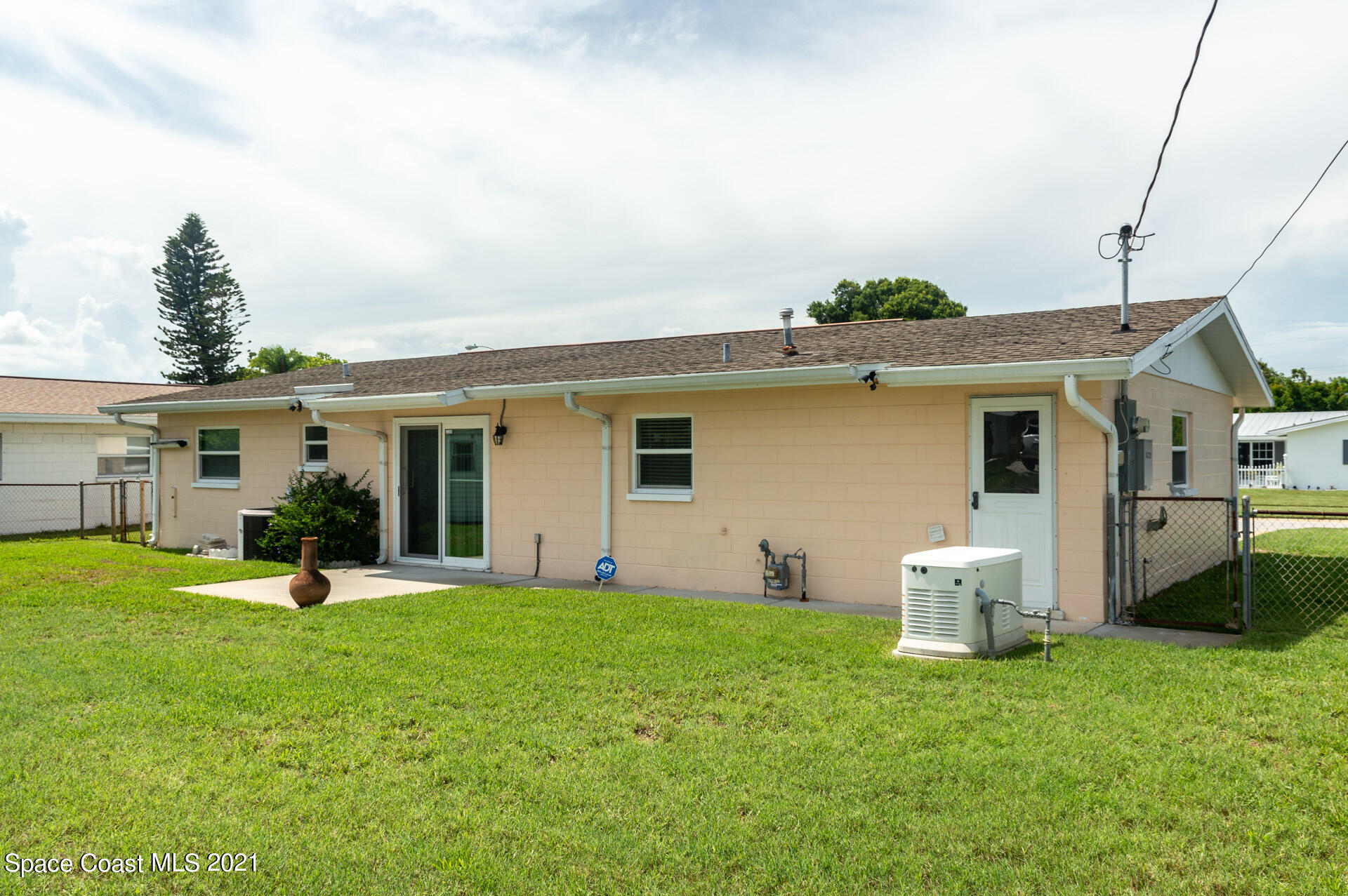 2435 Ricky Road Melbourne, FL 32935 - Photo 19 of 20 a front view of a house with a yard and trees