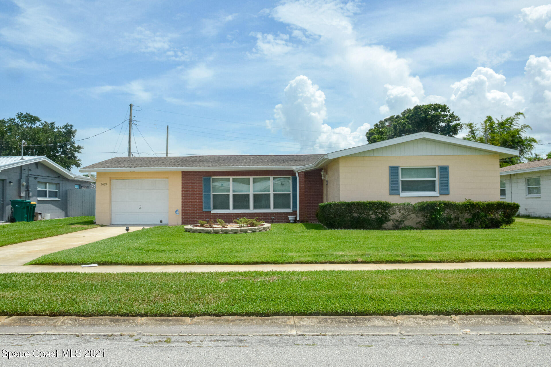 2435 Ricky Road Melbourne, FL 32935 - Photo 3 of 20 a front view of a house with a garden and yard
