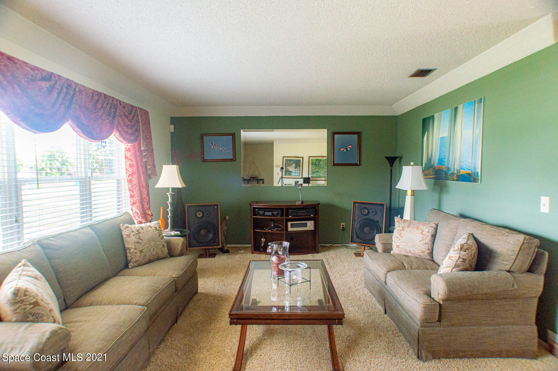 2435 Ricky Road Melbourne, FL 32935 - Photo 4 of 20 a living room with furniture and a large window