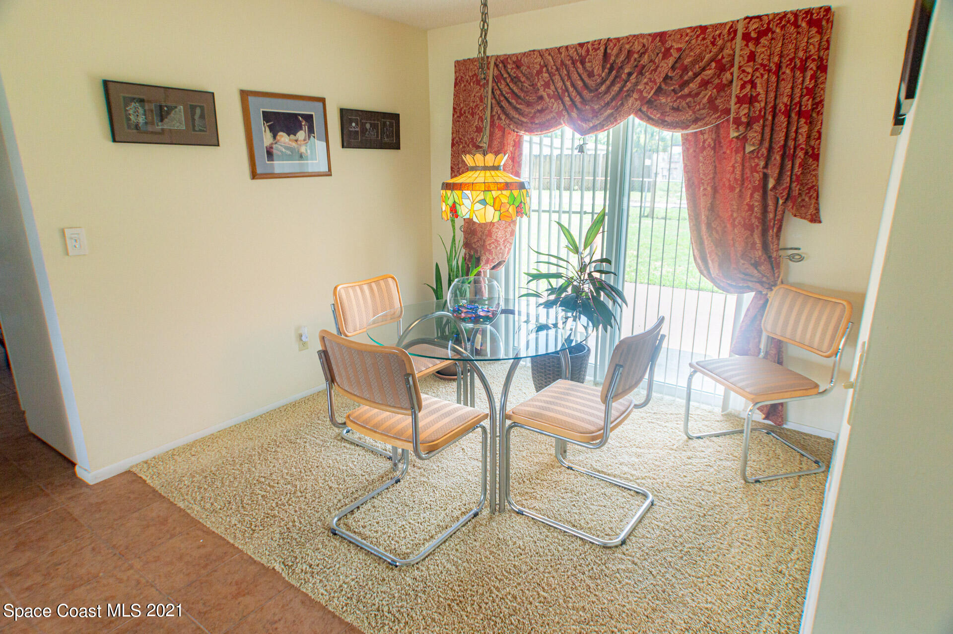 2435 Ricky Road Melbourne, FL 32935 - Photo 9 of 20 a view of a dining room with furniture and chandelier
