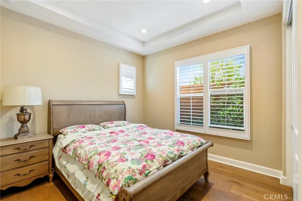 a bedroom with a bed and a lamp on dresser