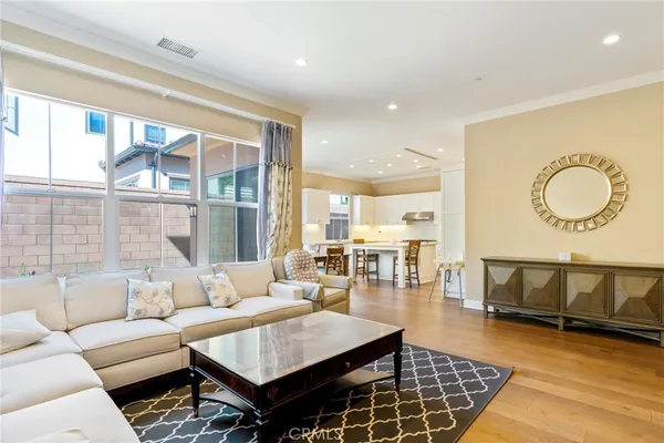 a living room with furniture a rug and a large window