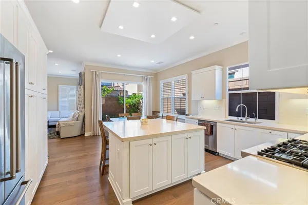 a large white kitchen with a sink stove and refrigerator