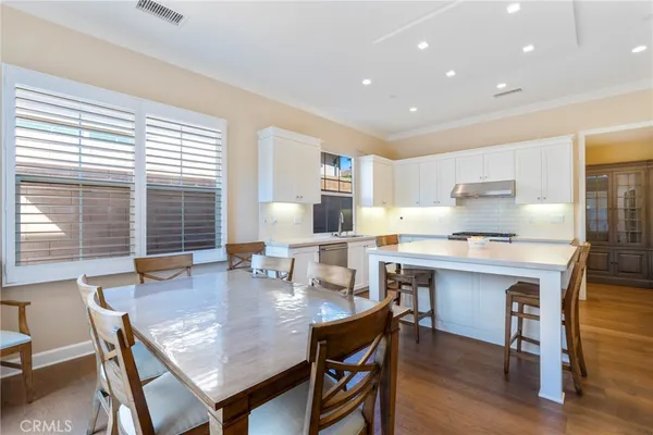 a dining room with a table chairs and wooden floor