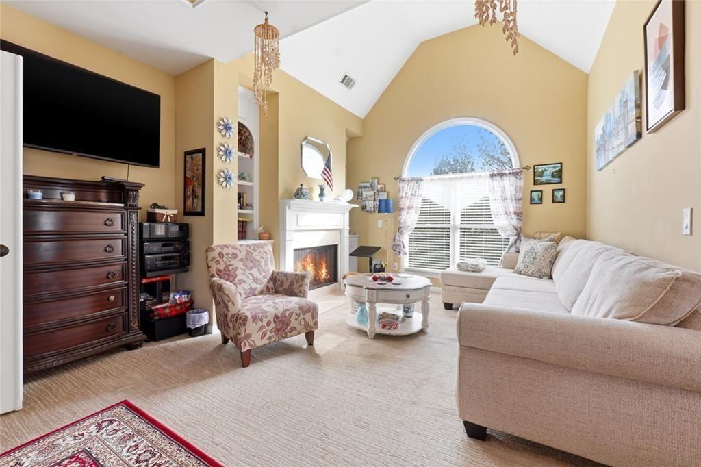 1915 Brackendale Road Northwest Kennesaw, GA 30152 - Photo 23 of 69 a living room with furniture a flat screen tv and a fireplace