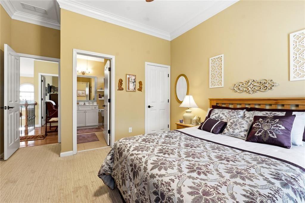 1915 Brackendale Road Northwest Kennesaw, GA 30152 - Photo 32 of 69 a bedroom with a large bed and a dresser