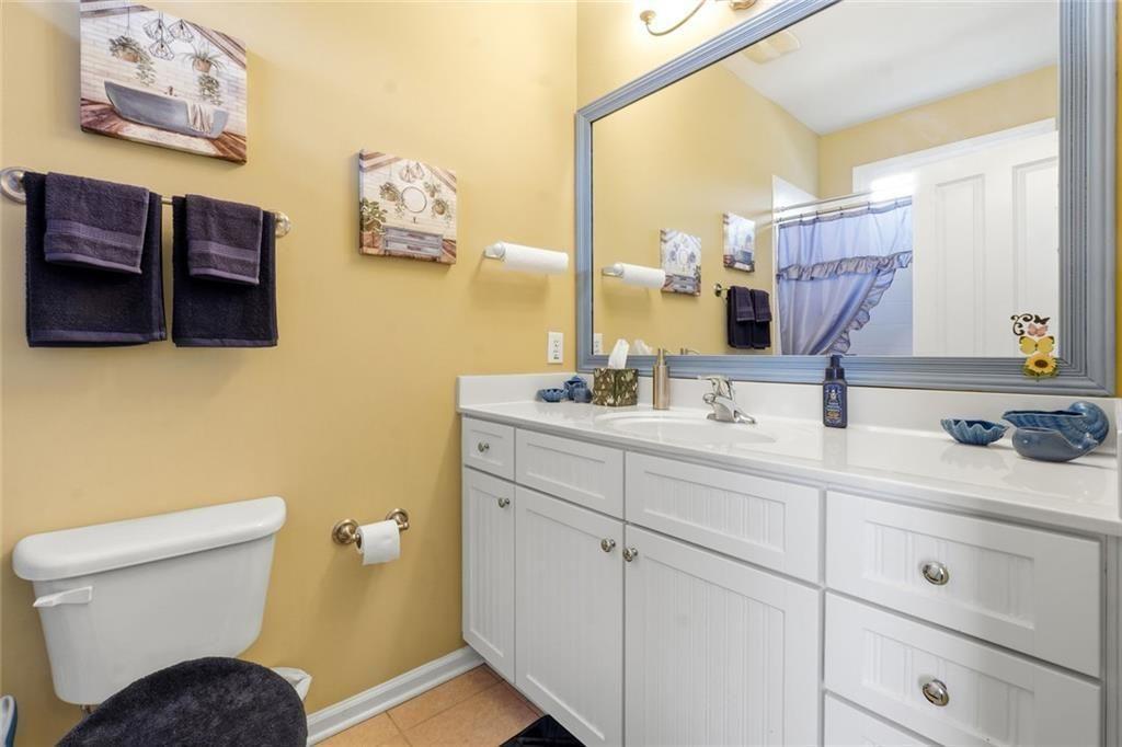 1915 Brackendale Road Northwest Kennesaw, GA 30152 - Photo 36 of 69 a bathroom with a toilet sink and mirror
