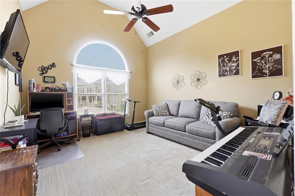 1915 Brackendale Road Northwest Kennesaw, GA 30152 - Photo 37 of 69 a living room with furniture a flat screen tv and a window
