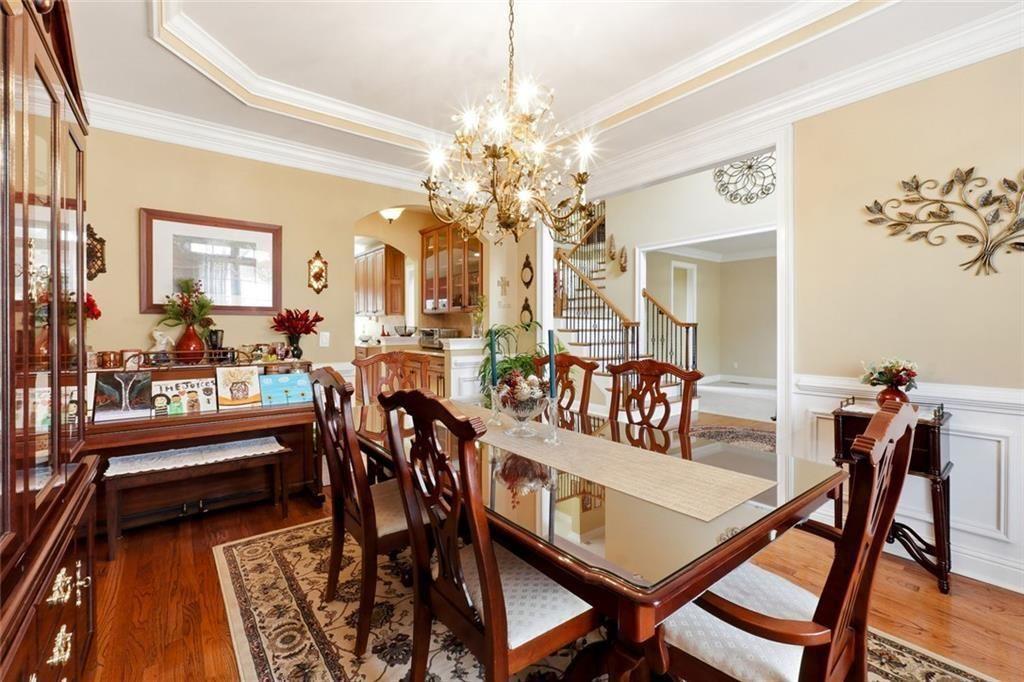 1915 Brackendale Road Northwest Kennesaw, GA 30152 - Photo 4 of 69 a view of a dining room and livingroom with furniture a rug a chandelier and wooden floor
