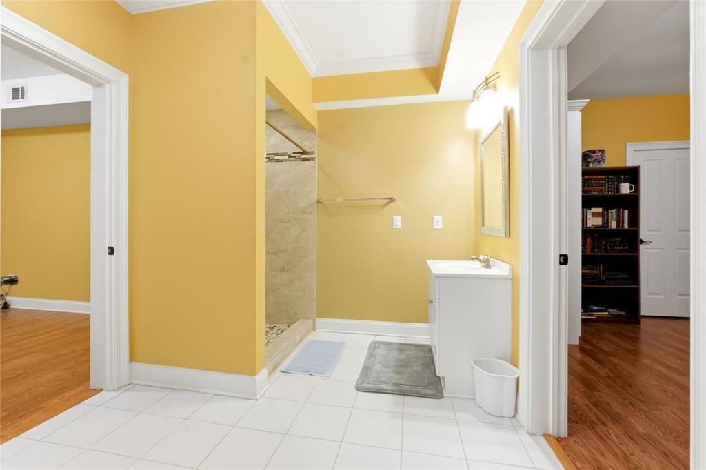 1915 Brackendale Road Northwest Kennesaw, GA 30152 - Photo 41 of 69 a bathroom with a glass door shower and a sink