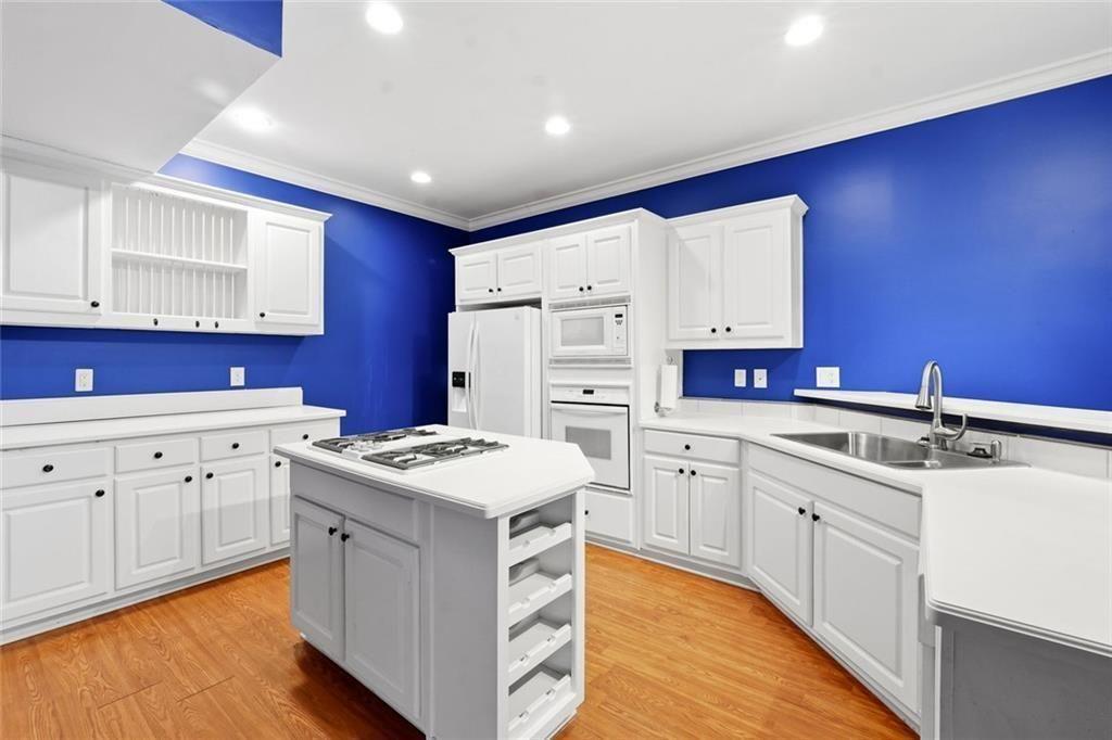 1915 Brackendale Road Northwest Kennesaw, GA 30152 - Photo 48 of 69 a kitchen with granite countertop a sink stove and cabinets