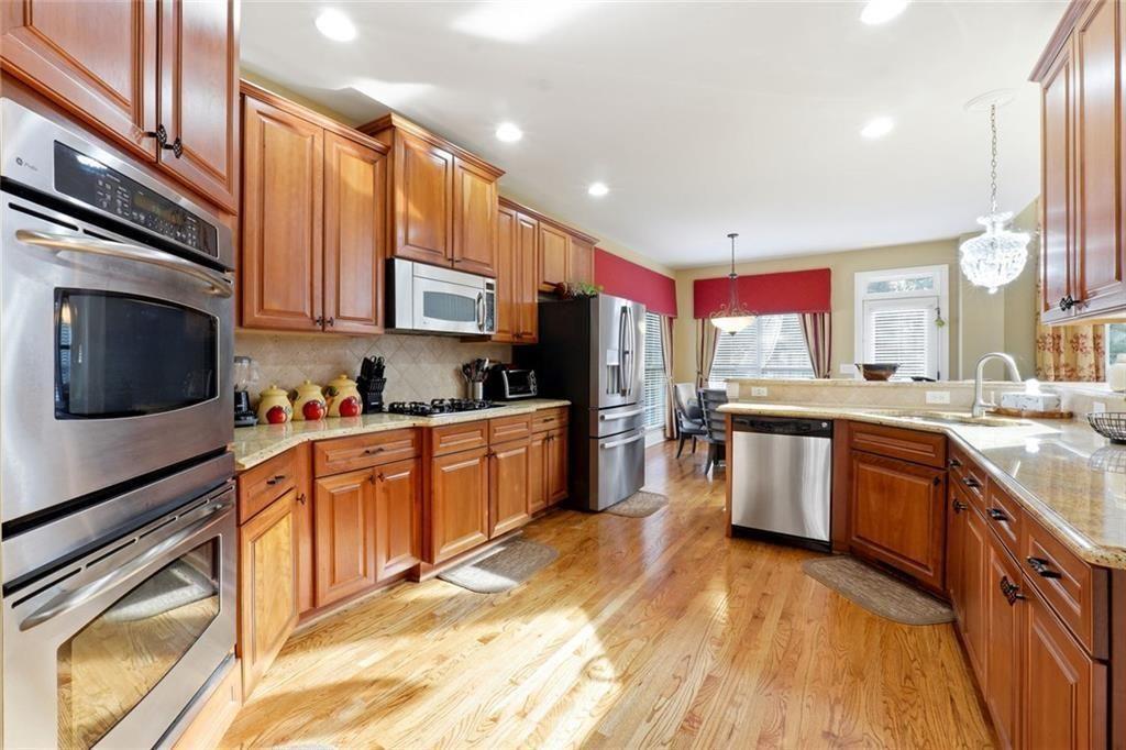 1915 Brackendale Road Northwest Kennesaw, GA 30152 - Photo 5 of 69 a kitchen with stainless steel appliances granite countertop a stove a sink and a refrigerator