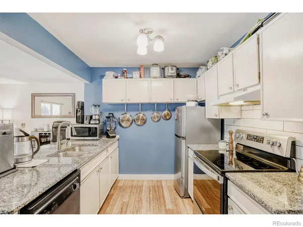 a kitchen with a sink appliances and cabinets