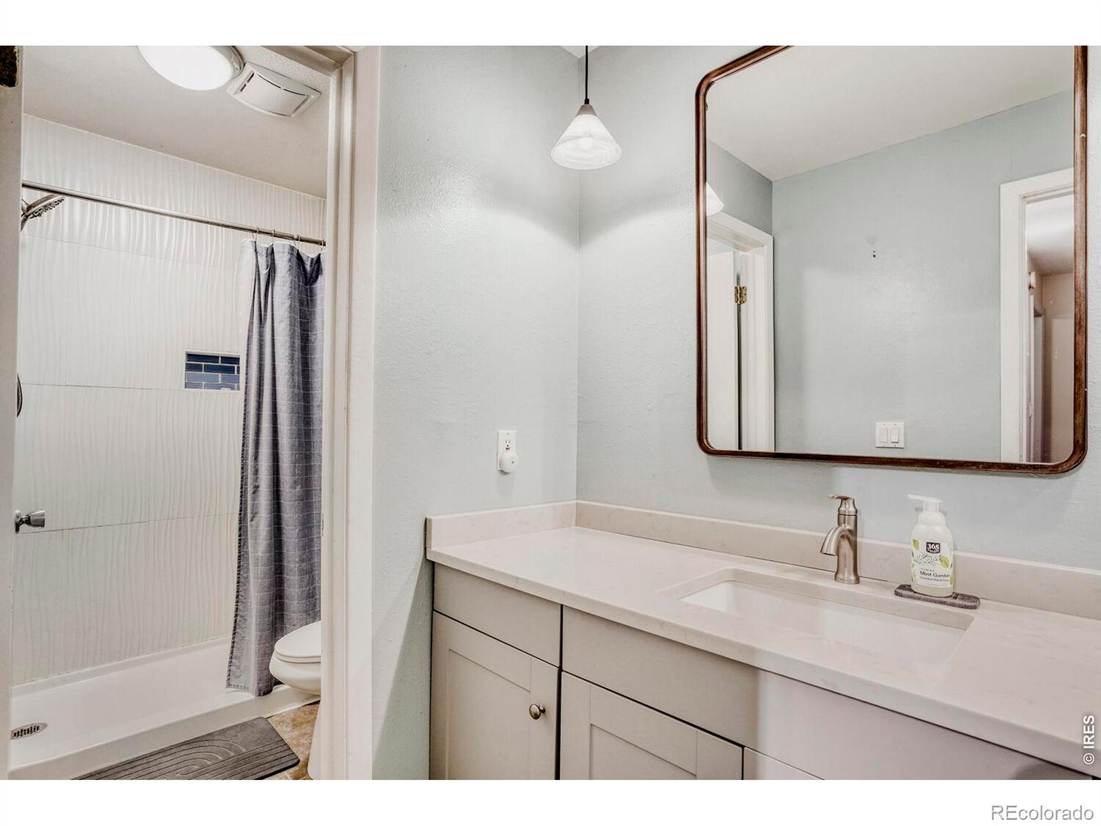1895 Alpine Avenue, Unit G22 Boulder, CO 80304 - Photo 18 of 33 a bathroom with a sink and a mirror