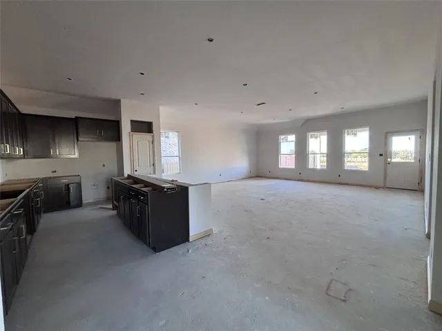a kitchen with stainless steel appliances granite countertop a stove refrigerator and cabinets