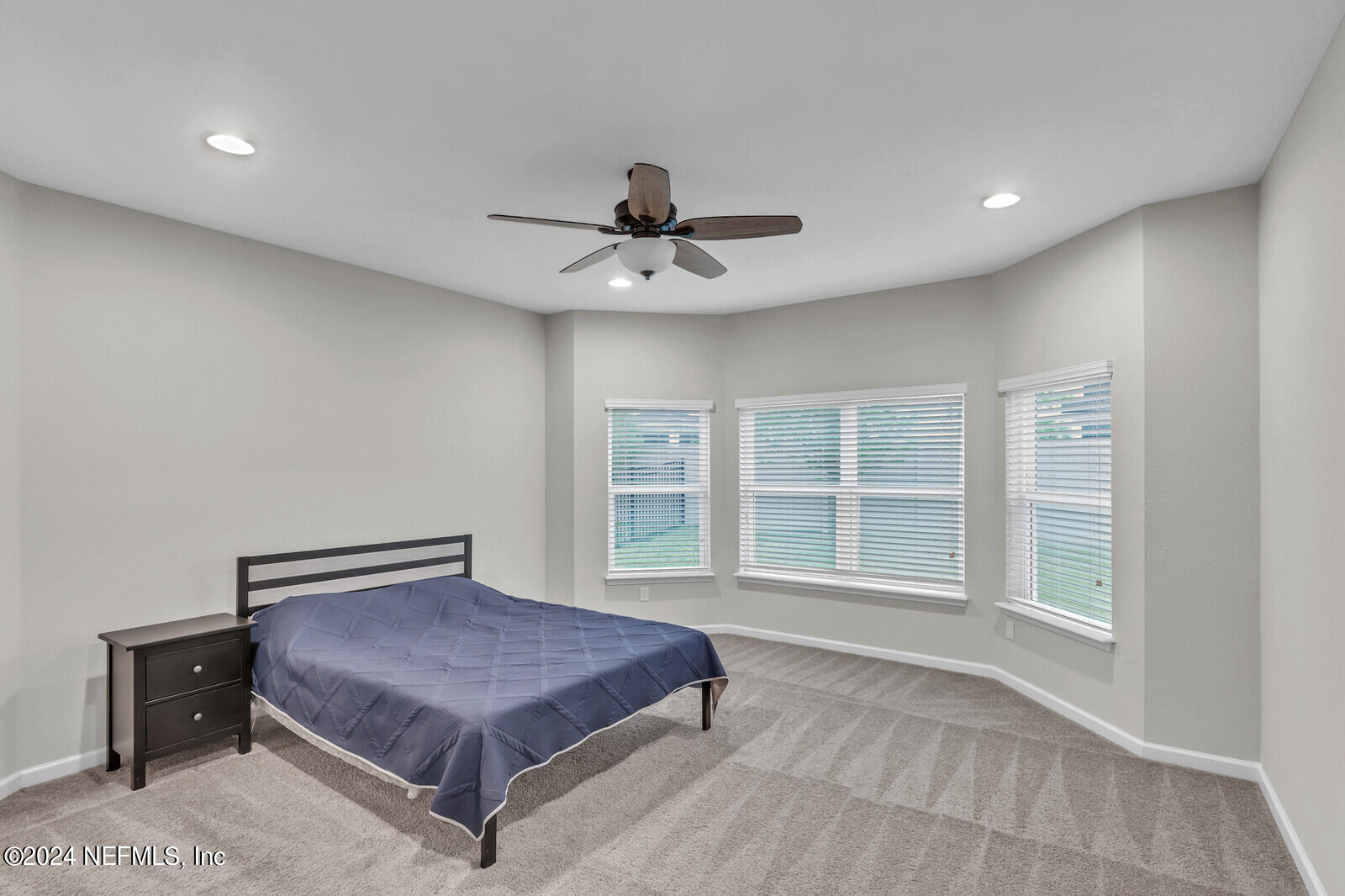 364 Beale Avenue St. Augustine, FL 32092 - Photo 16 of 54 a spacious bedroom with a bed and a chandelier