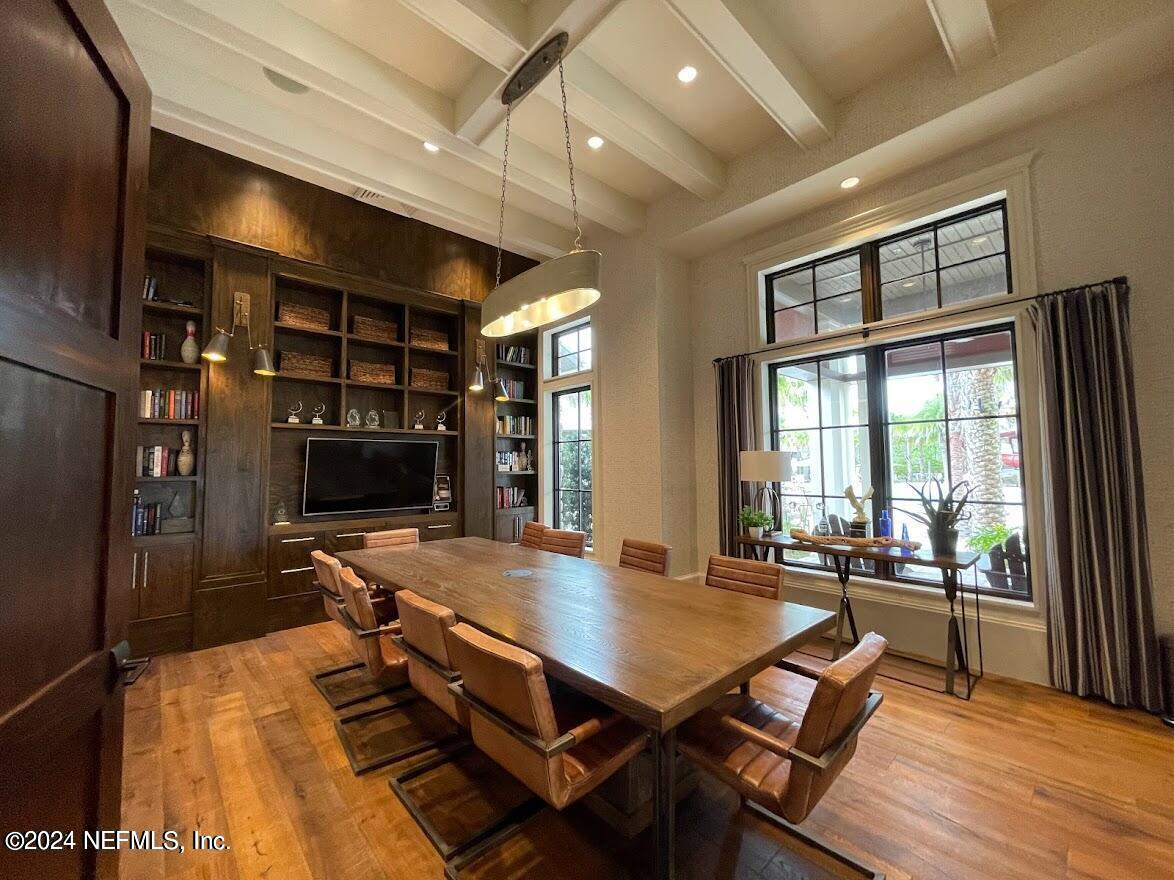 364 Beale Avenue St. Augustine, FL 32092 - Photo 44 of 54 a living room with furniture a flat screen tv and floor to ceiling window