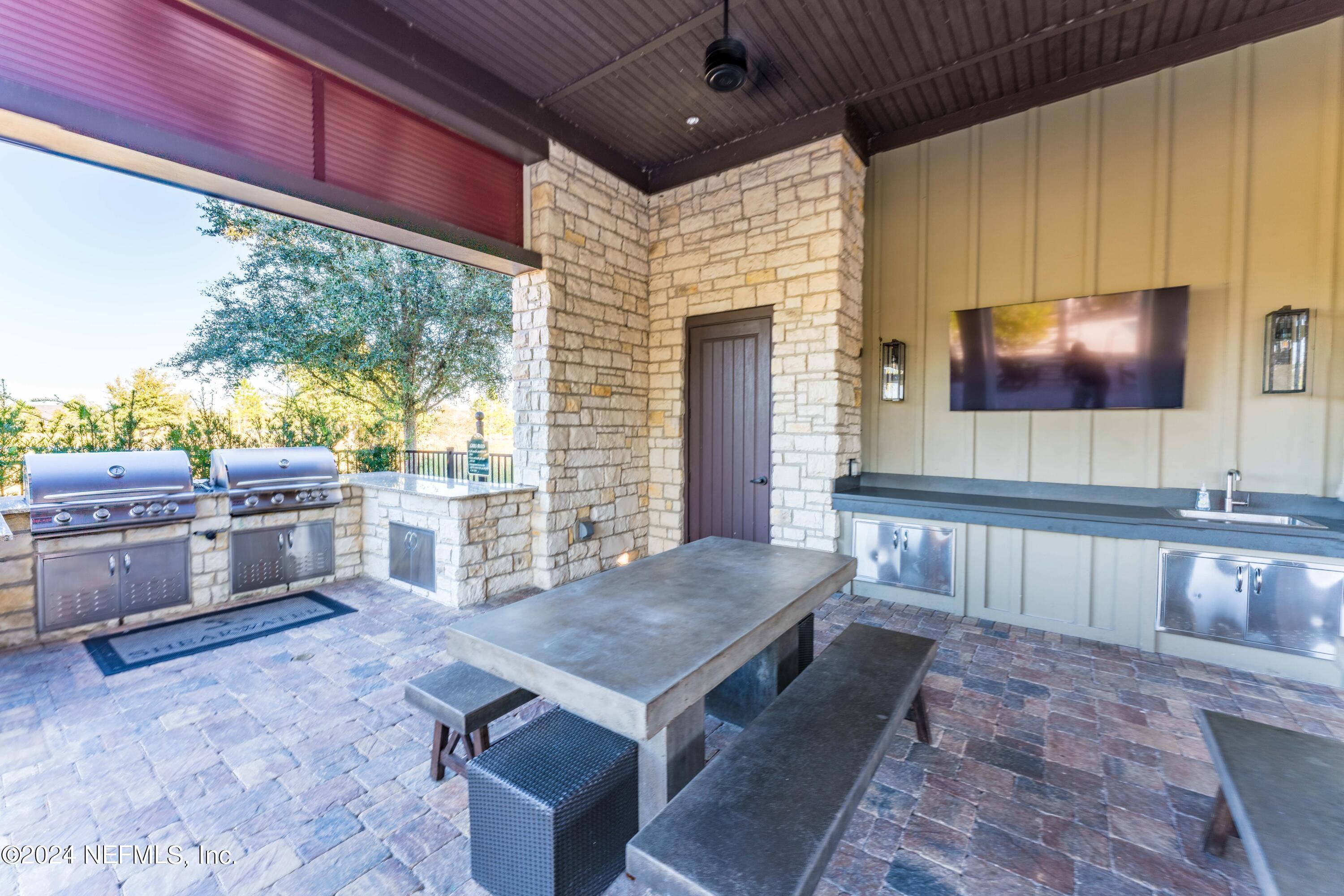 364 Beale Avenue St. Augustine, FL 32092 - Photo 51 of 54 a living room with stainless steel appliances kitchen island granite countertop furniture and a flat screen tv