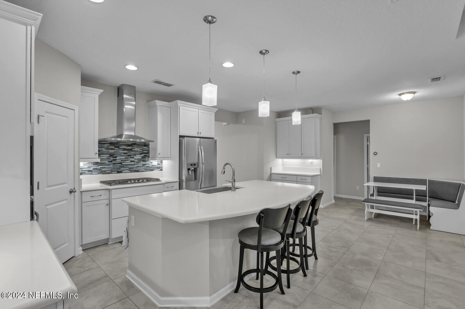 364 Beale Avenue St. Augustine, FL 32092 - Photo 7 of 54 a kitchen with kitchen island a stove a table and chairs