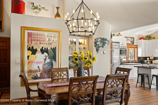 a view of a patio with dining table and chairs under an umbrella with a patio