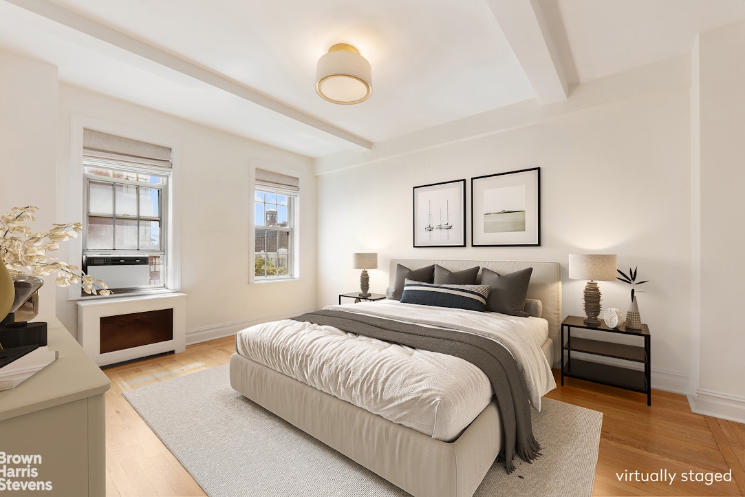 24 5th Avenue, Unit 909 Manhattan, NY 10011 - Photo 4 of 11 a spacious bedroom with a bed and a chandelier