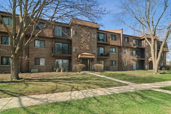 a view of a brick building next to a yard