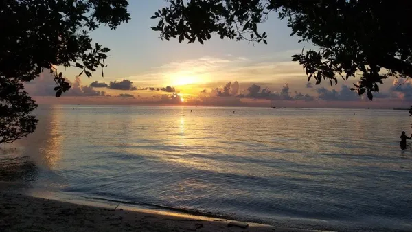 an ocean view with beach and outdoor seating