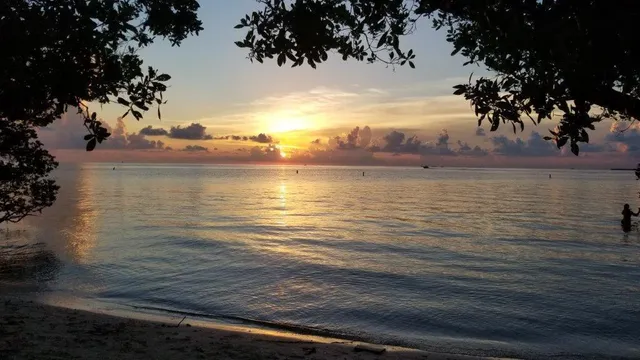 an ocean view with beach and outdoor seating
