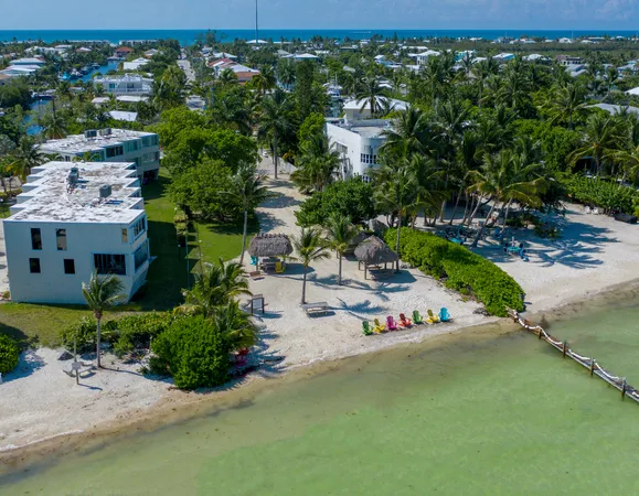 a view of a street with cars parked in front of it