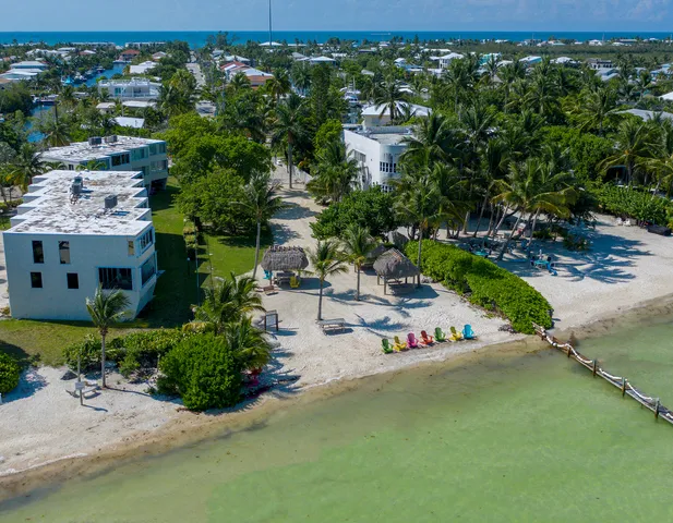 a view of a street with cars parked in front of it