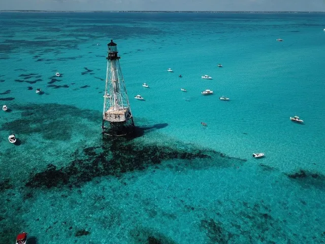 a view of a lake with lawn chairs and a yard