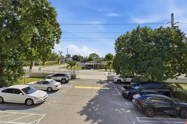 a view of a street with cars parked