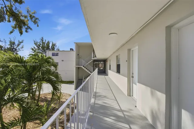 a view of staircase with railing and a potted plant
