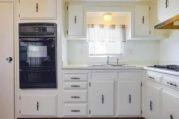 a view of a hallway with a livingroom with furniture