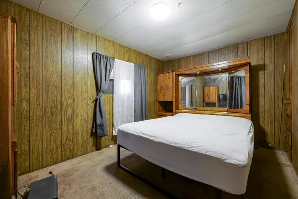 a room with a bed and a dresser