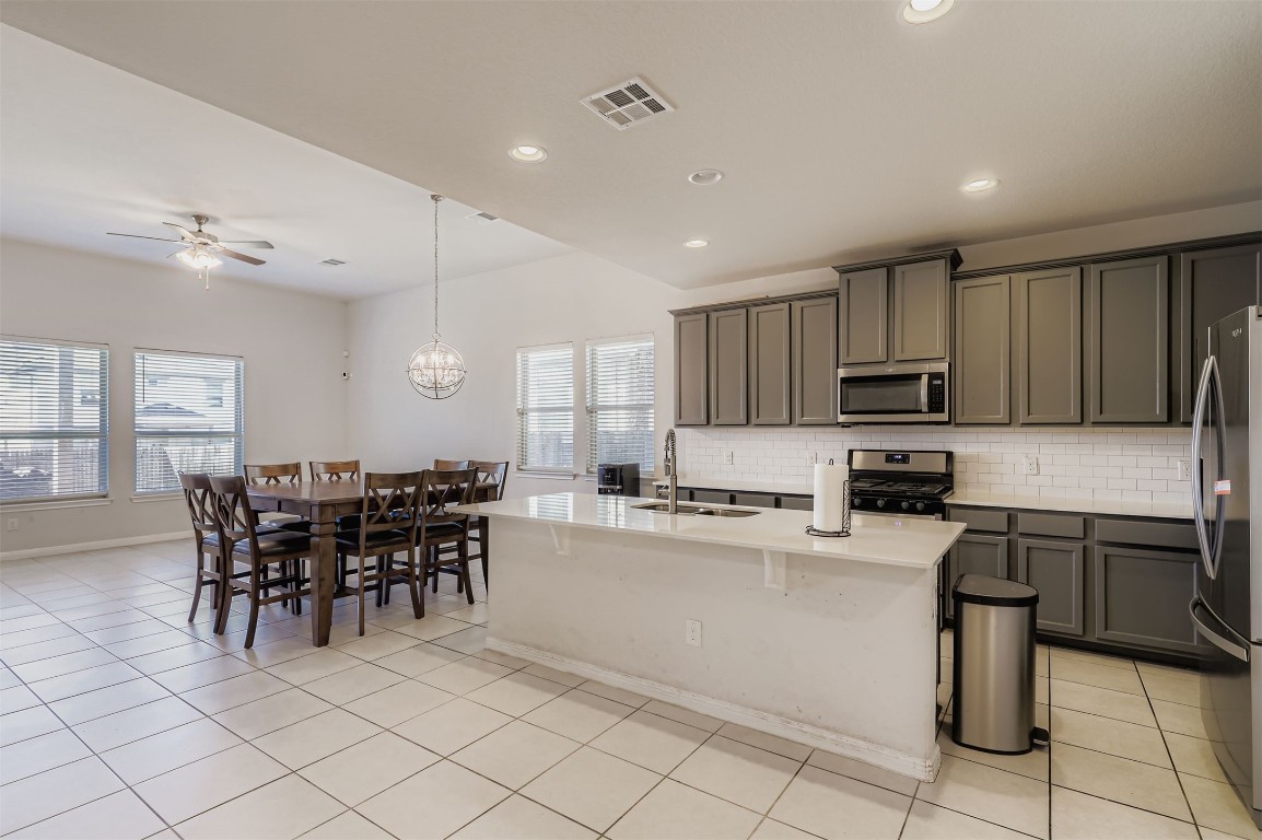 400 Somerville Street Leander, TX 78641 - Photo 4 of 11 a kitchen with microwave a stove and cabinets