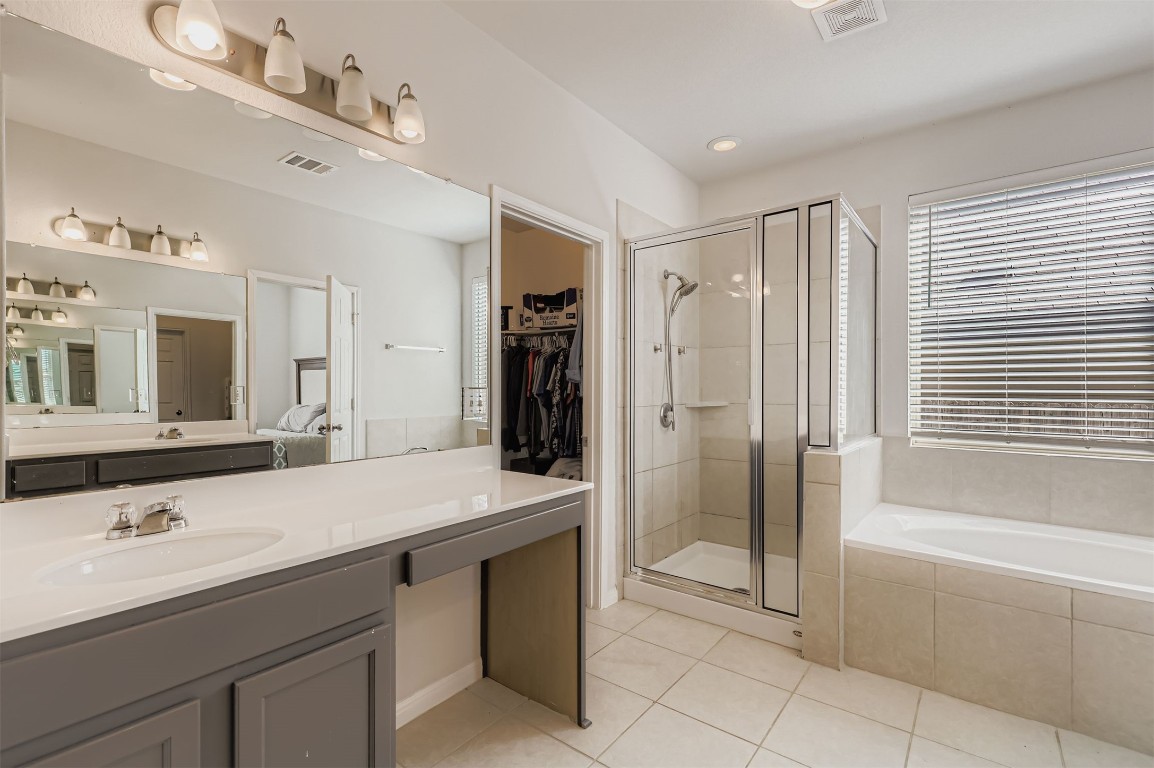 400 Somerville Street Leander, TX 78641 - Photo 6 of 11 a bathroom with a granite countertop sink mirror and a bathtub