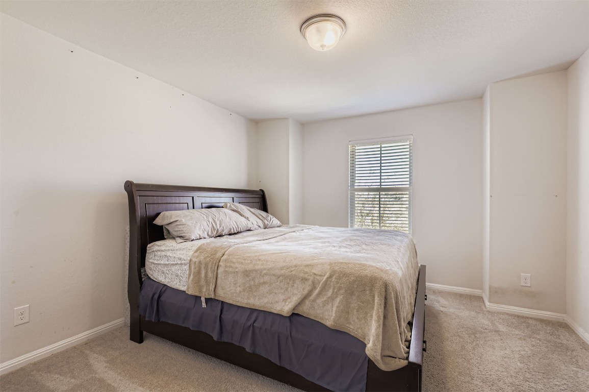 400 Somerville Street Leander, TX 78641 - Photo 9 of 11 a bedroom with a bed and window