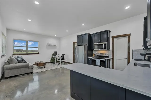 a living room with furniture a rug and a chandelier