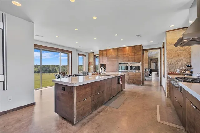 a living room with furniture fireplace and a large window