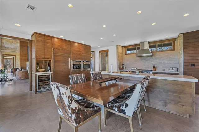 a living room with furniture a flat screen tv and a floor to ceiling window