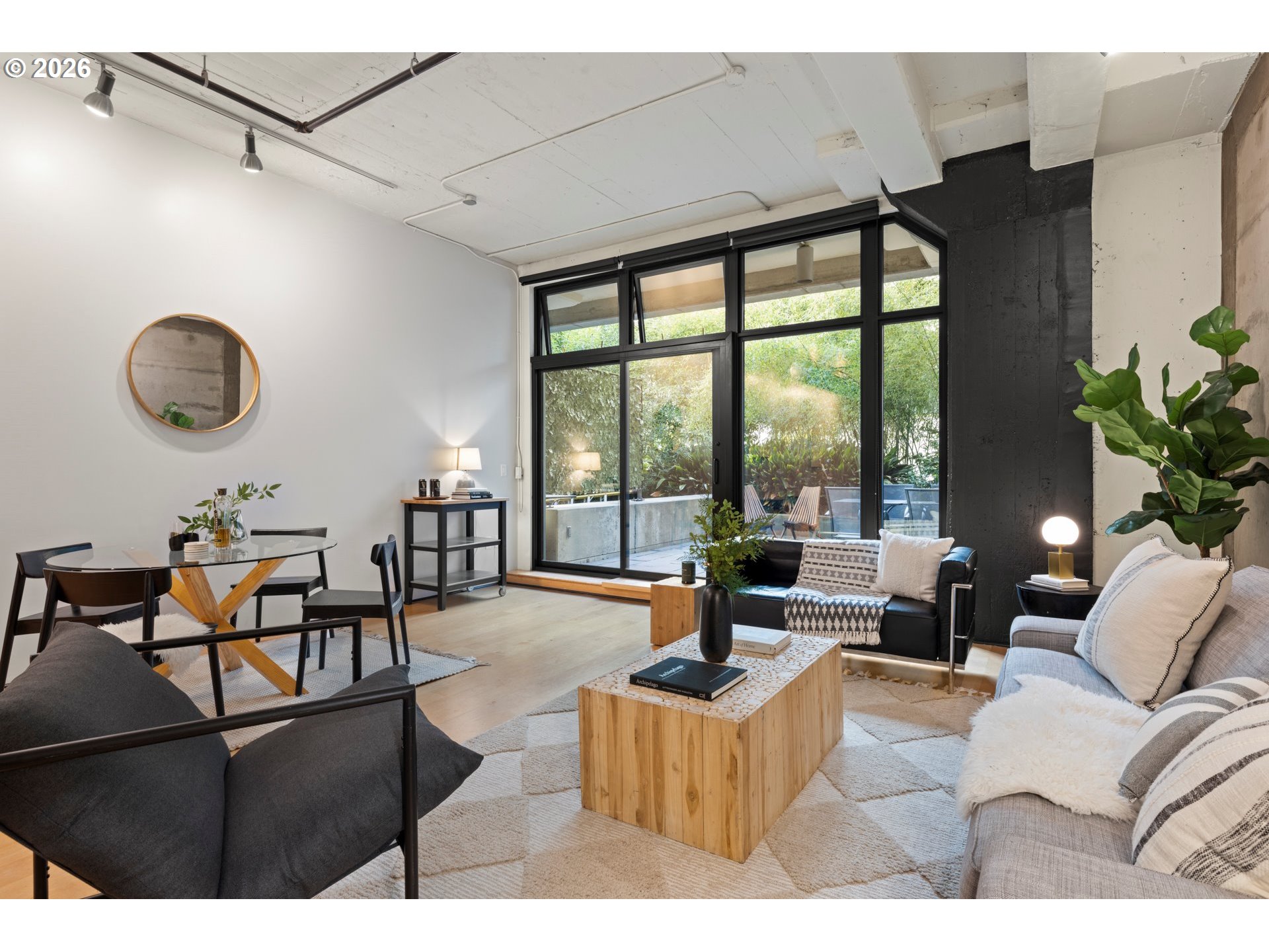 1400 Northwest Irving Street, Unit 322 Portland, OR 97209 - Photo 11 of 27 a living room with furniture and floor to ceiling windows