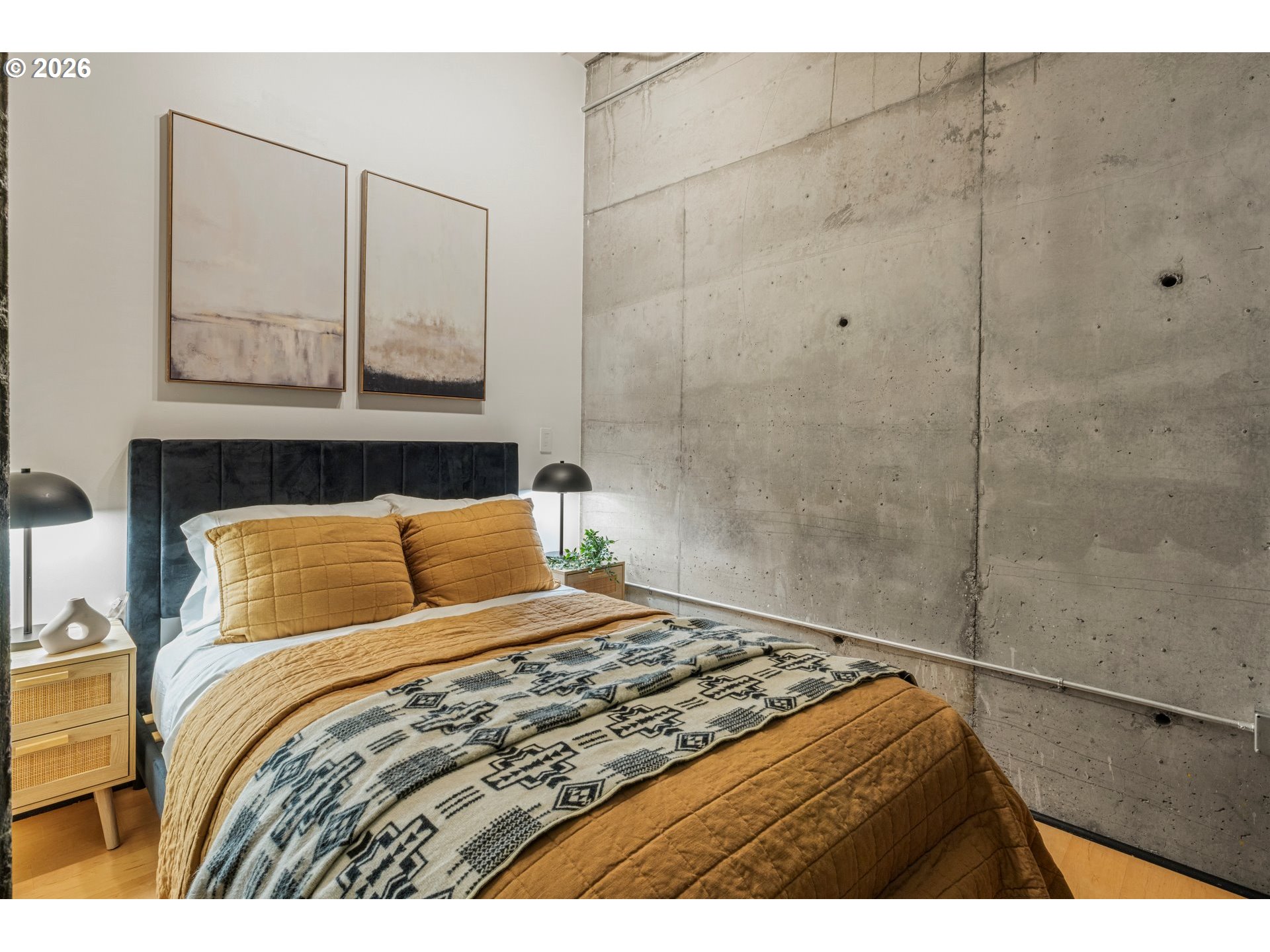 1400 Northwest Irving Street, Unit 322 Portland, OR 97209 - Photo 16 of 27 a bedroom with a bed and a painting on the wall