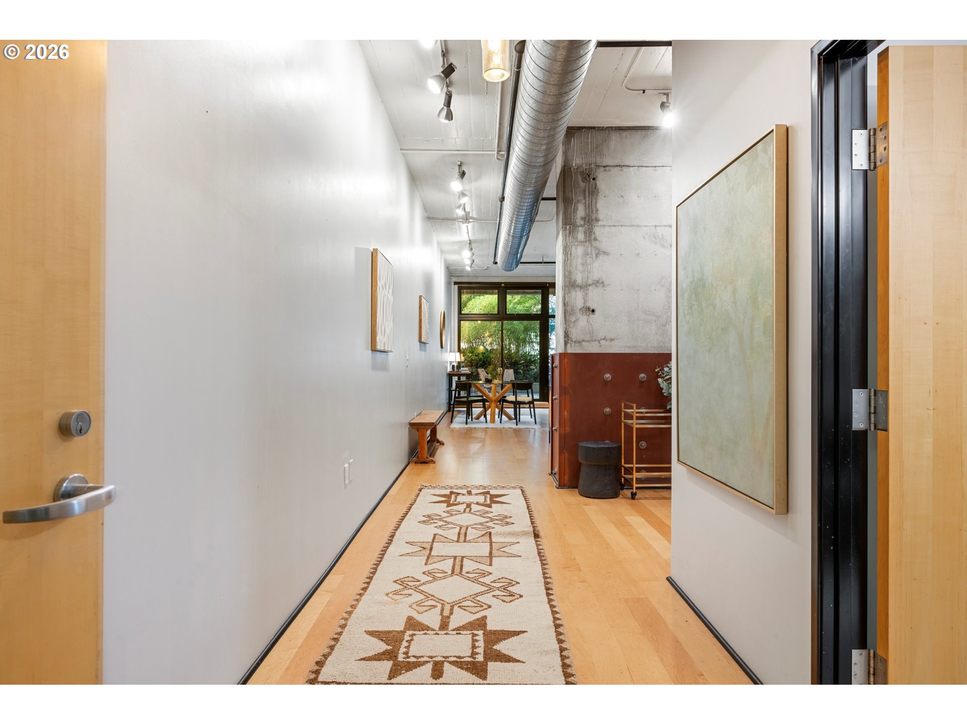 1400 Northwest Irving Street, Unit 322 Portland, OR 97209 - Photo 4 of 27 a hallway with a large window and wooden floor