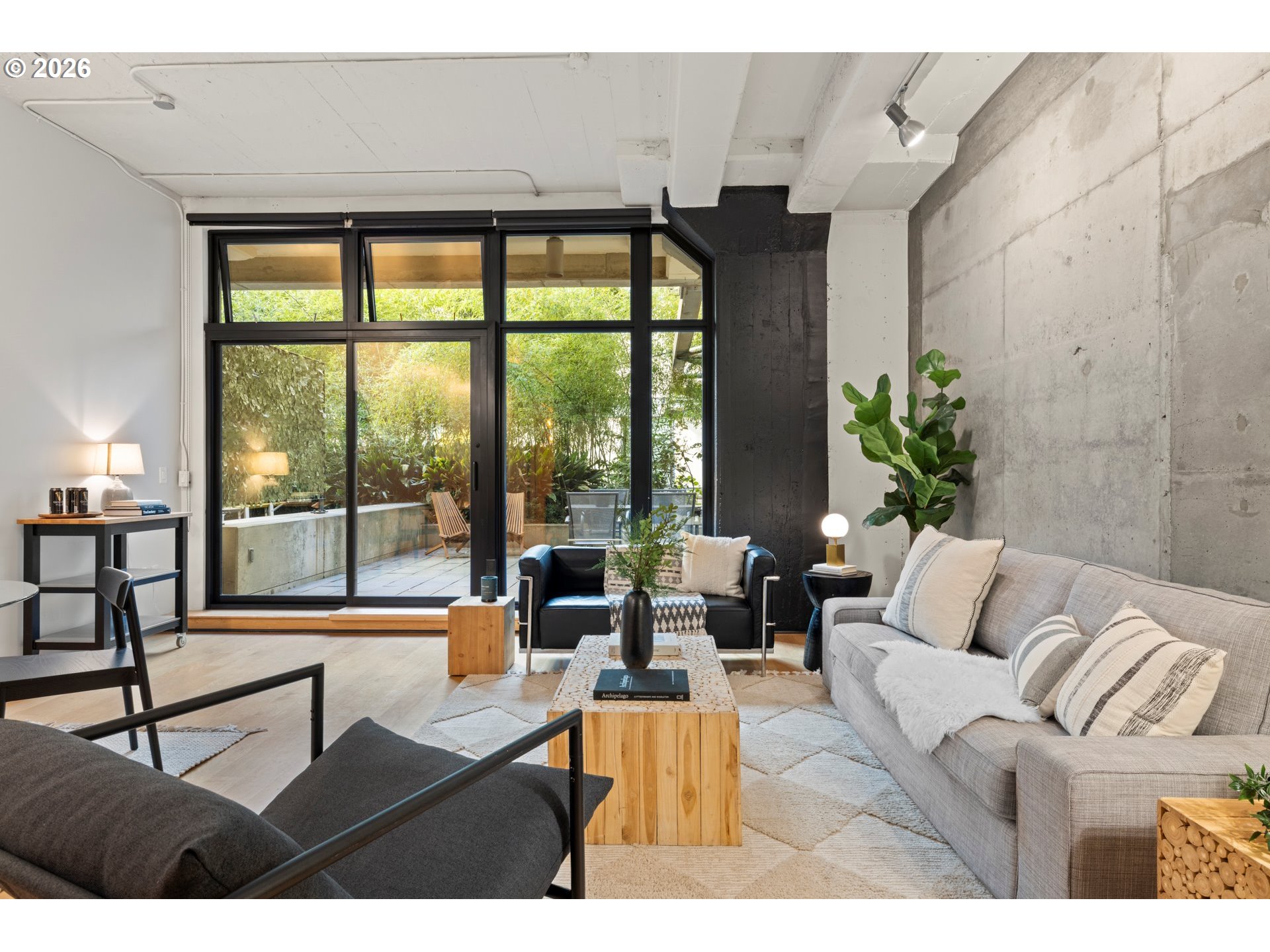 1400 Northwest Irving Street, Unit 322 Portland, OR 97209 - Photo 10 of 27 a living room with furniture and floor to ceiling windows