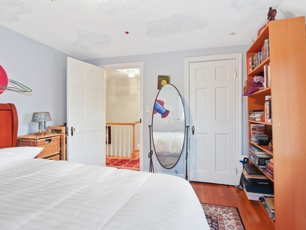 52 Beverly Road Wellesley, MA 02481 - Photo 24 of 41 a bedroom with a bed and a chandelier