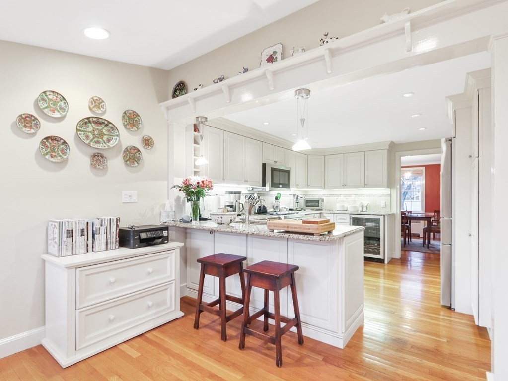 52 Beverly Road Wellesley, MA 02481 - Photo 3 of 41 a kitchen with a dining table chairs cabinets and wooden floor